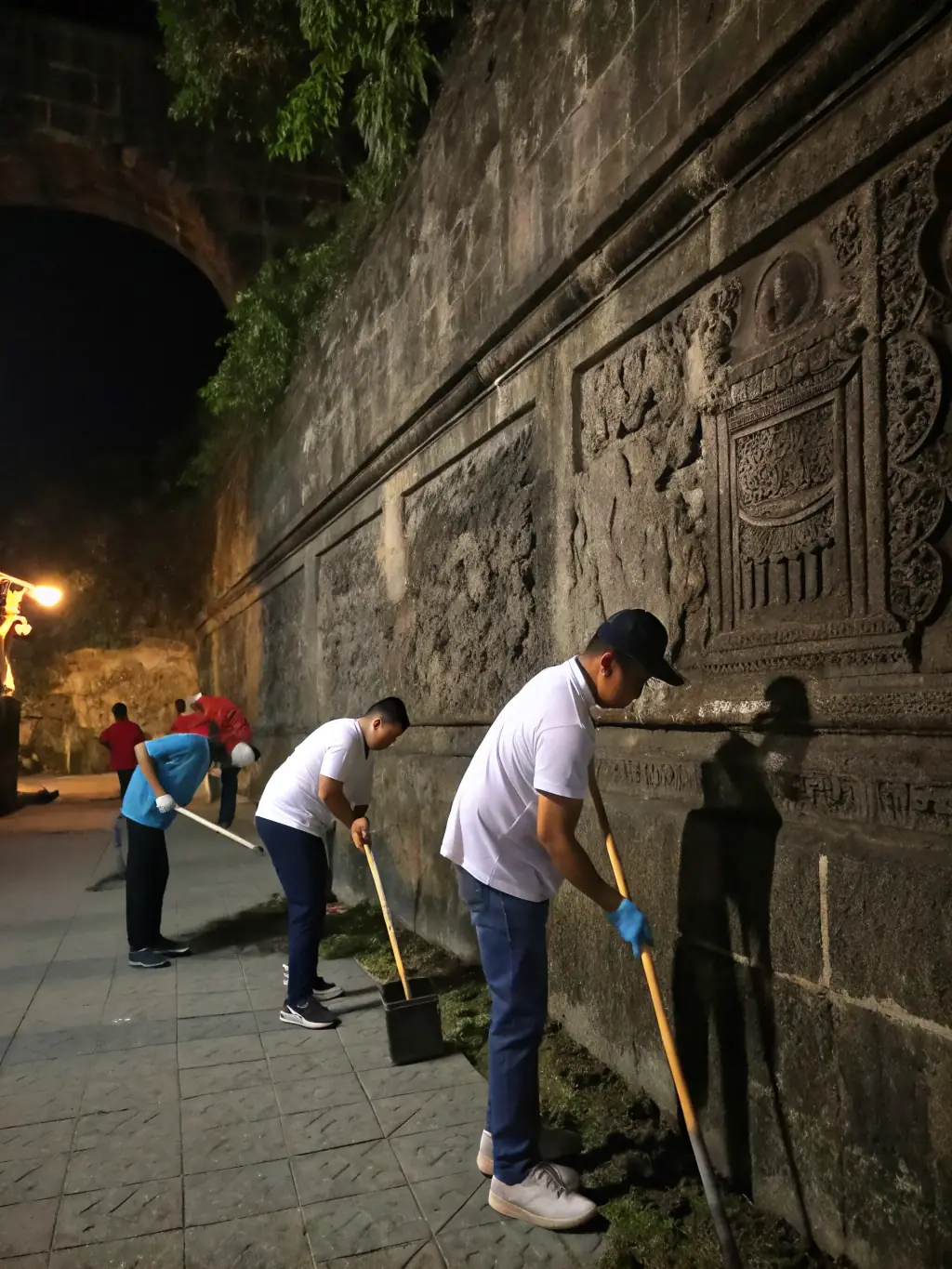 A photograph capturing volunteers cleaning and restoring an old stone wall in Reallon, showcasing the tangible heritage preservation efforts of REALLONNAIS HERITAGE.